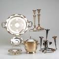 Silver plate seven pieces poole insulated ice bucket pair of art deco candlesticks grapevine bordered twohandled tray pair of grapevine bordered footed candy dishes leaf and vine form epergne