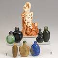Snuff bottle grouping eight items 20th c carved coral with jungle scene carved lapis lazuli jade harstone etc tallest 6