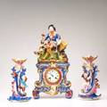 Old paris porcelain three piece clock garniture set 20th c decorated with a seated huntsman above clock and two candlesticks one with a boy and the other with a girl clock 19 34 x 10 12 x 4
