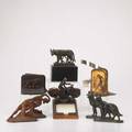 Decorative library accessories eleven pieces 20th c four pairs of bookends include nudes german shepards golfers and lions marked bradley and hubbard vintage motorcyclist note pad holder etc