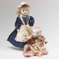 German bisque head dolls two early 20th c grace s putnam byelo baby and bisque head and shoulder doll in original clothing with additional clothes both marked taller 22