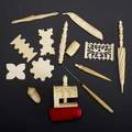 Ivory or bone sewing utensils fourteen pieces 19th20th c stiletto barrelshaped powderer acornshaped powderer set of four flat winders pierced and carved winder clamp with red pincushion g