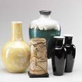 Asian grouping five vases 20th c pair of black baluster vases gourdshaped with enamel flowers on yellow ground faux tusk with relief design and large vase with fish and waterlilies most marked