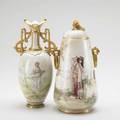 Continental porcelain two gilttrimmed vessels ca 1900 vase depicting a young woman holding a flower garland and covered jar depicting a young woman resting along a wall vase signed a heidrich