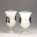 Steuben two alabaster and black glass urns one stamped 11 34 and 12