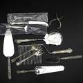 Sterling serving utensils twentyeight items ten assorted servers with steel blades include cake slices and comb and cheese servers some new in box eighteen solid implements include sugar tongs s