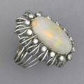 Diamond and opal cocktail ring oval opal with full spectrum pinfire approx 7 cts surrounded by diamonds approx 84 ct tw in hand built 14k wg 122 gs gw size 8