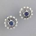Diamond and sapphire earrings sapphires each 33 ct framed by full cut diamond accents 50 ct tw in 14k wg with screwback closures ca 1960 61 gs gw 58 diameter
