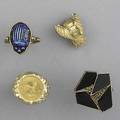 Gold rings and a pin four pieces including iridescent scarab ring hieroglyphic obverse unmarked onyx inlay 1982 110 oz gold krugerrand all in 14k yg 327 gs gw sizes 6 12  9 12
