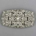 Art deco diamond platinum openwork brooch principal diamond 25 with diamond melee approx 120 cts tw trumpet clasp ca 1920 104 gs gw 2 18 x 1 14