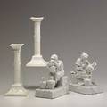Blanc de chine pair of classical greek candlesticks and pair of figural bookends all 20th c tallest 9 34