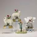 European porcelain three staffordshire sheep bud vases together with a vase depicting a woman by a stream 19th20th c tallest 8 34