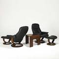 Ekornes pair of adjustable leather and wood laminate lounge chairs ottomans and matching table marked chair 39 x 31 x 32 ottoman 16 x 20 12 x 16 table 19 12 x 27 x 24