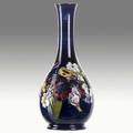 Moorcroft bottleshaped vase with orchids stamped moorcroft made in england 10 14 x 4 14