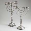 Two silver menorahs each with eight branches and shammash the larger with oil pitcher 20th c 716 ot taller 25
