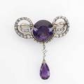 Amethyst and diamond corsage ornament ca 1880 diamond loops encircle a faceted circular amethyst 27 x 20 mm approx 75 cts suspends 22 mm pearshaped amethyst and approx 60 ct squareshaped di