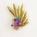 Gemset gold furclip 18k yg diamond accented feathers ruby and sapphire cabochons and leafshaped diamond triplet clusters ca 1955 double pin back unrecognized trademark cho six corundum app