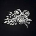 Diamond and platinum brooch ca 1950 designed as a floral spray of prong set marquise pearshaped and brilliant cut diamonds and baguette cut diamond ribbons three principal pearshaped diamonds ap