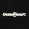 F walter lawrence diamond platinum brooch openwork bar with fine oec and omc diamonds millegrain borders ca 1920 marked fwl inc principal diamond is approx 2 cts flanked by eight diamonds 2