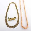 Three pieces of gold jewelry ca 1960 textured 14k and diamond fringe necklace germany 16 12 graduated salmon coral bead necklace 22 enameled 18k trotter brooch 2 14 brooch and fringe neck