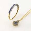 Sapphire and diamond 14k gold jewelry hinged bracelet with lines of circular faceted sapphires 4 cts diamonds in wg bezels 80 ct oval cluster pendant on double chain principal sapphire approx