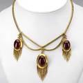 Gold and garnet fringed girandole necklace ca 1860 18k bloomed gold snakelink festoon suspends three garnetset pendants with icicle fringe the central element with glazed compartment obverse 404