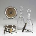Wine accessories seven pieces 19th c pair of crystal decanters two silver plate bottle coasters and three corkscrews tallest 11 12