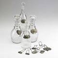 Wine accessories seventeen pieces 19th20th c four crystal decanting bottles and thirteen bottle tags five in sterling tallest 11