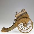 Mechanical wine cradle brass in the form of a cannon 19th20th c 12 12 x 9 12 x 6
