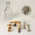 Wine accessories seven pieces 19th20th century two corkscrews three bottle openers silver plate wine coaster crystal decanter 10