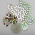 Collection of jade or nephrite jewelry 20th century white jade bead necklace with chinese carved mossinsnow pendant chinese carved celadon floral button 2 58 d two strands of beads