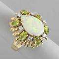 Opal diamond and gemstone cocktail ring ca 1970 pearshaped opal 17 x 11 x 5 mm centers textured gold bombe with six brilliant cut diamonds approx 50 ct tw and 6 leaf green gems 78 dwt g