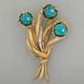 Jeweled 18k bouquet brooch ca 1960 textured with carved blue gem blossoms and diamond accents 152 dwt 236 gs 2 78