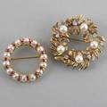 Two jeweled 14k wreath brooches ca 19601970 sculptural foliate wreath with diamonds approx 30 ct tw circle brooch of alternating pearls and faceted rubies 155 dwt gw 241 gs gw largest