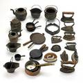 Copper and cast iron miniatures twentythree items 19th20th c including wagner sidney o waffle iron sensible 6 sad iron brass and copper pans etc tallest 4 12