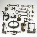 Door knockers and hardware twentythree items in wrought iron cast iron or brass 18th19th c including five hand and ball knockers figural door pull etc largest 7 dia