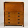 Gustav stickley dropfront desk with fitted interior and two over three drawers quartersawn oak with patinated iron pulls early 20th c red compass mark 46 x 36 12 x 15