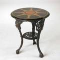 Wrought iron garden table base decorated with faces of women faux marble top 20th c 28 x 24 dia