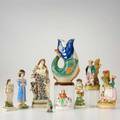English staffordshire eight figurines mid 19th c together with a majolica pitcher in the shape of a fish damage to most tallest 9