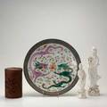 Asian group four pieces 19th20th c two blanc de chine ladies of mercy figures republic period charger with unglazed border and fighting dragons and carved cylindrical wooden box decorated with w