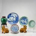 Asian porcelain and pottery nine pieces 20th c pair of foo dogs celadon plate celadon and blue and white scalloped edge bowl green monochrome ginger jar etc some marked tallest 9 12