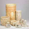 Weller eight creamware pieces ivory jardiniere cylindrical vase low planter and umbrella stand together with cameo chamberstick and low bowl and pair of coatofarms chambersticks all unmarked u