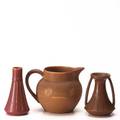 Rookwood three production vessels 19091910 pitcher twohandled vellum vase in matte brown and bud vase in matte red all impressed flame mark tallest 6 12