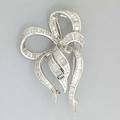Diamond platinum ribbon brooch by fabricant ny ca 1955 graceful design of shimmering tapered rows of fine baguette cut diamonds approx 550 cts tw with hinged doublepin closure unmarked 149