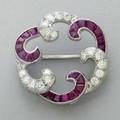Oscar heyman ruby diamond platinum brooch ca 1955 circular swirls of bead set brilliant cut diamonds approx 107 cts tw and channel set calibrated cut translucent rubies approx 313 cts tw