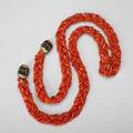 Red coral rope with fluted onyx gold terminals five strand braid of tubular red coral beads average 8mm x 4mm cushionshaped fluted onyx and 14k yg terminals 2056 dwt gw 3197 gs gw 44 12