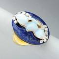 Lapis and opal diamond ring ca 19801990 chinese carved opal of a female figure possibly guanyin worn framed by brilliant cut diamonds on an oval lapis cushion in 18k yg maker mark unidentified