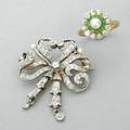 Edwardian diamond brooch and ring pendantbrooch of platinum topped gold designed as a ribbon bow with bell flower drops and seed pearl accents 18k yg cluster ring centers a pearl within concentric
