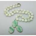 Jade necklace and pendant 20th century 28 strand of 1225mm beads and a gold enhancer formed of 3 pierced oval panels 3