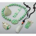 Chinese jade jewelry 19th20th century six pieces carved white jade pendant and coral bead on cord two carved jade panels mounted in gold as pendants carved panel old mutton fat pendant in the f